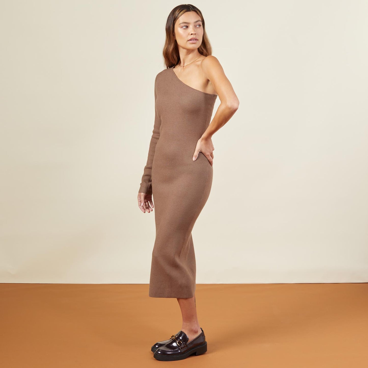 Side view of model wearing the supersoft sweater knit one shoulder dress in dusty cocoa.
