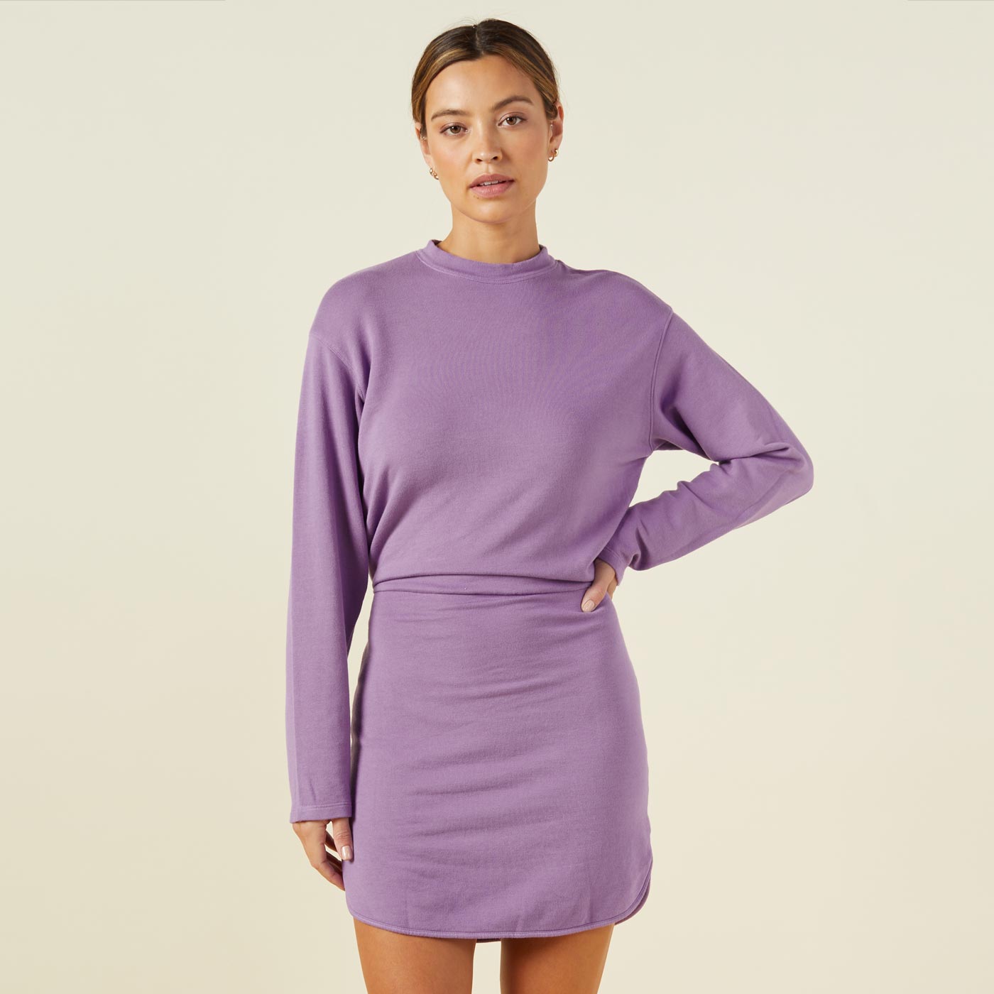 Front view of model wearing the supersoft fleece sweatshirt dress in aster purple.