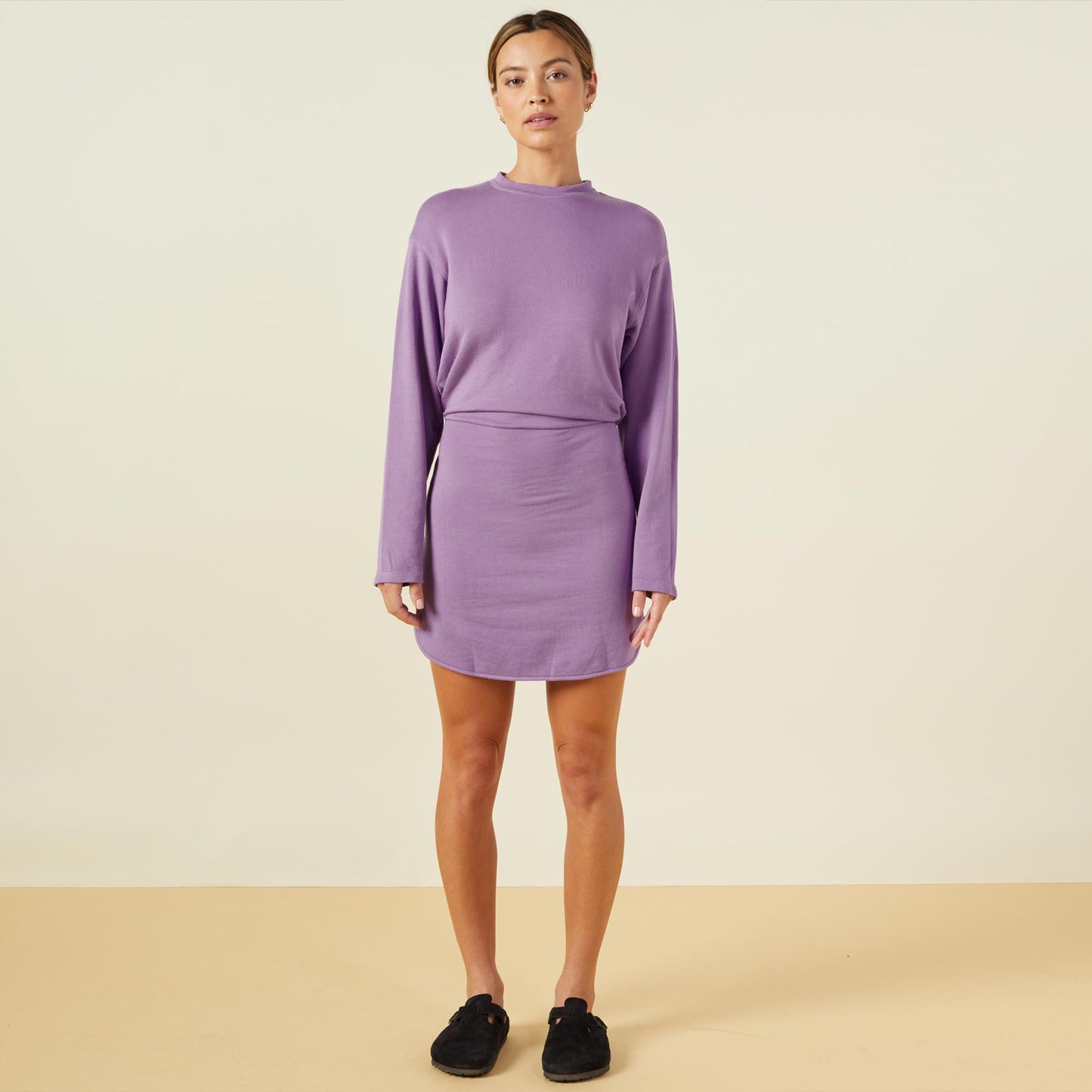 Front view of model wearing the supersoft fleece sweatshirt dress in aster purple.