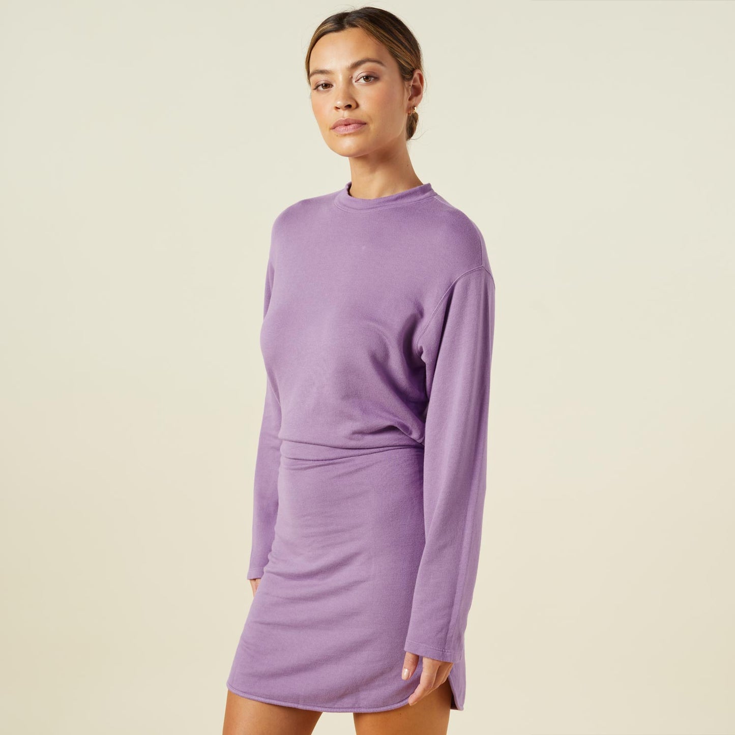 Side view of model wearing the supersoft fleece sweatshirt dress in aster purple.