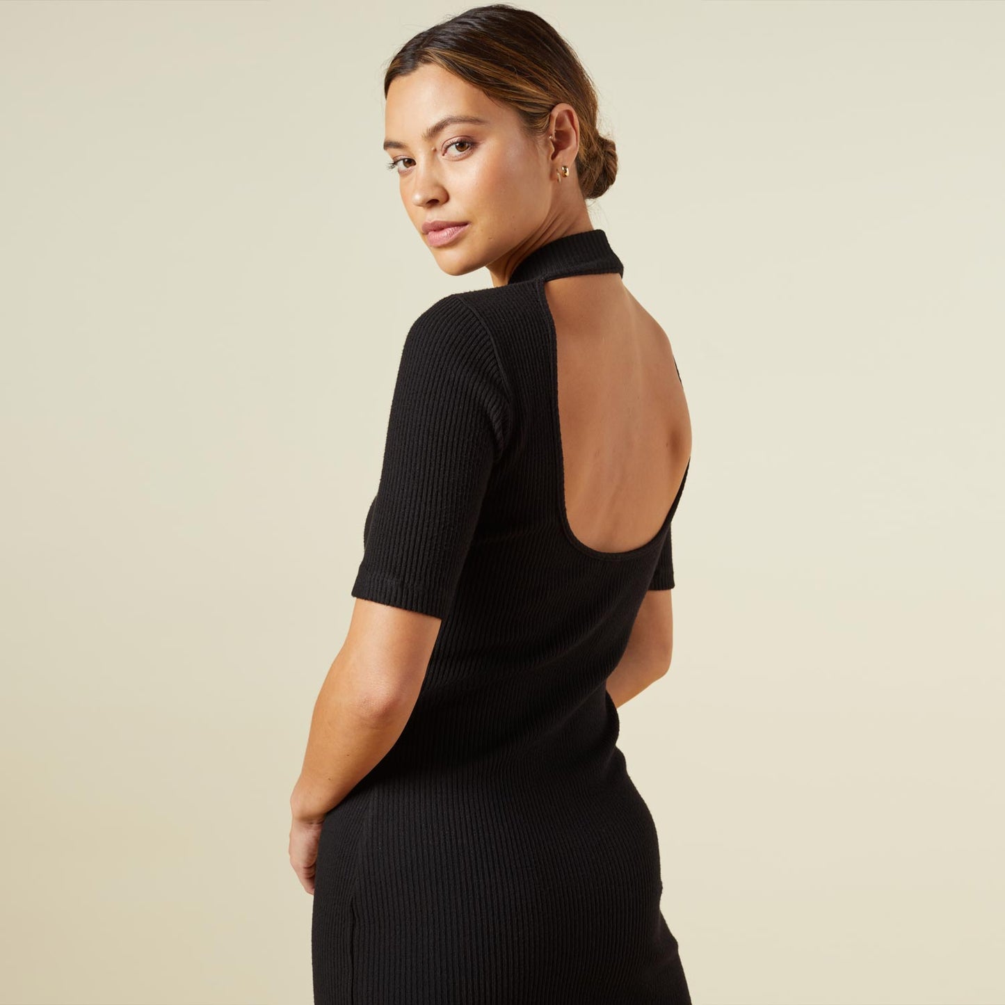Close up view of model wearing the brushed rib mock neck dress in black.