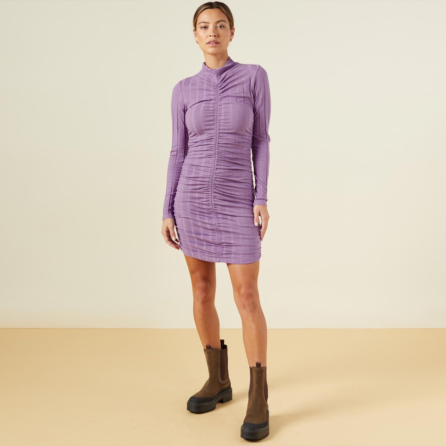 Front view of model wearing the flat rib mock shirred dress in aster purple.