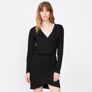 Front view of model wearing the supersoft fleece crossover v dress in black.