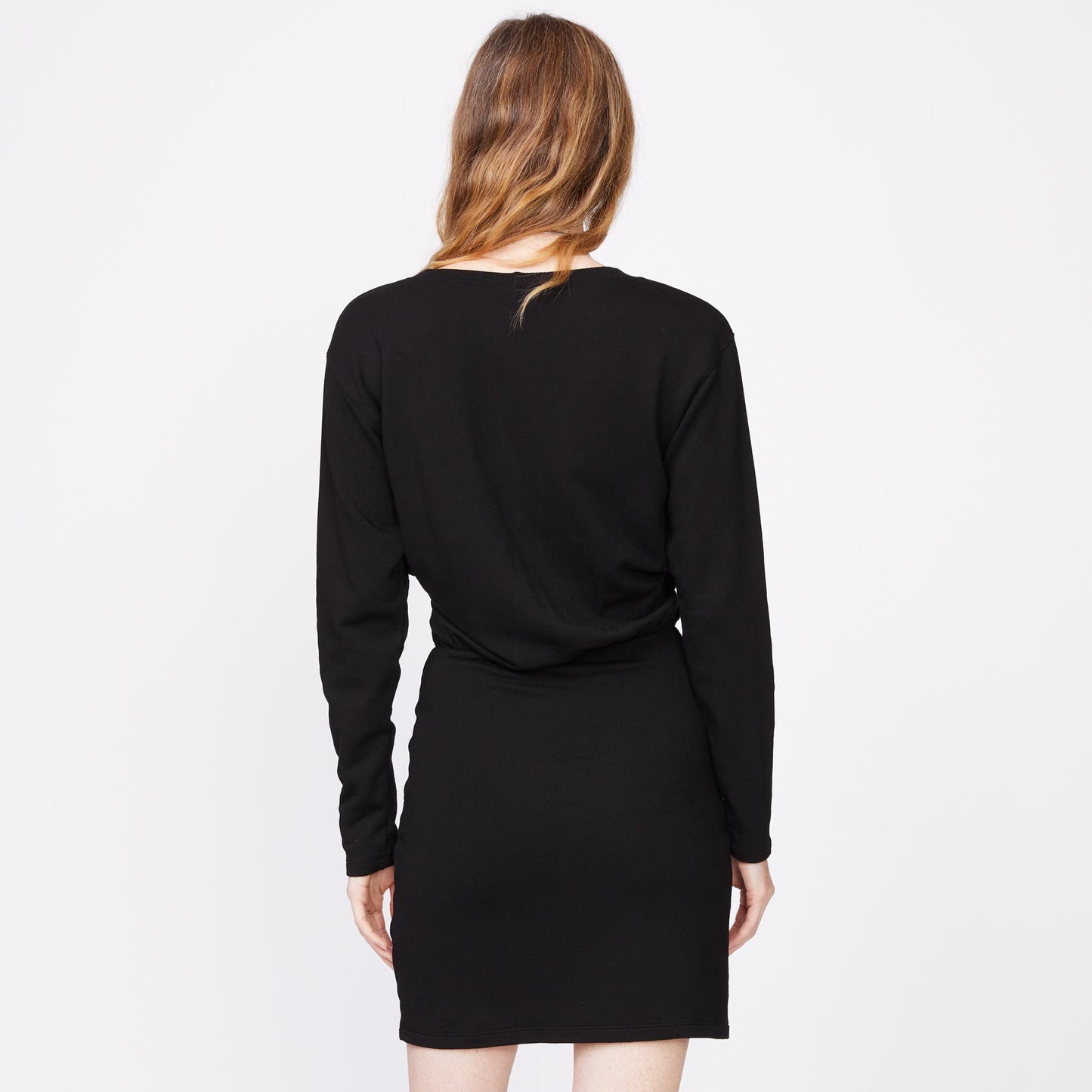 Back view of model wearing the supersoft fleece crossover v dress in black.