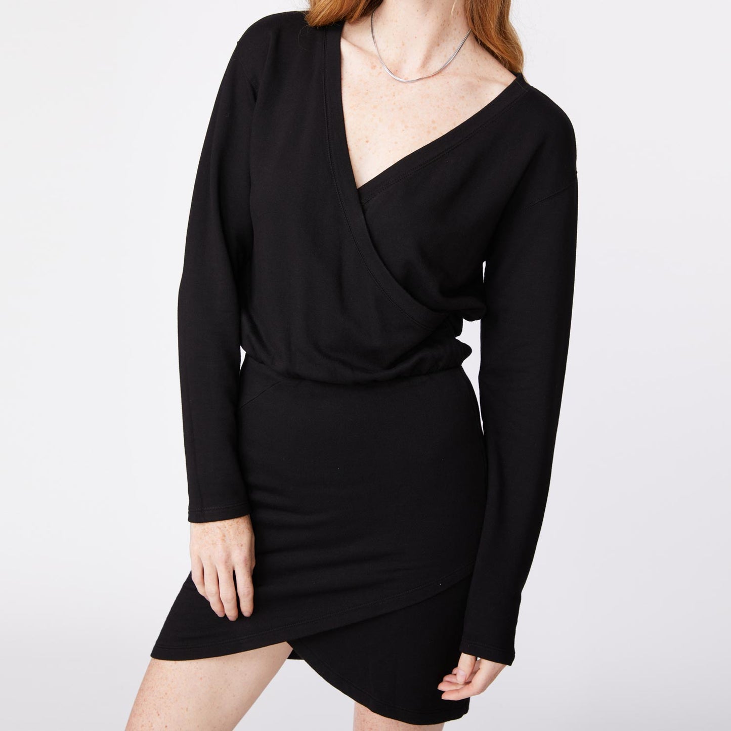 Close up view of model wearing the supersoft fleece crossover v dress in black.