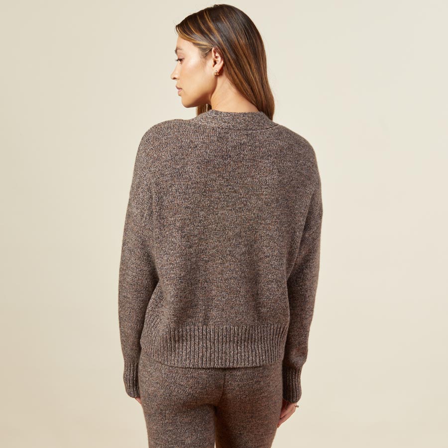 Back view of model in the marled oversized cardigan in black sesame.