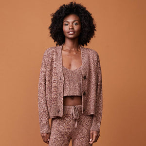 Front view of model wearing the marled oversized cardigan in pomegranate.