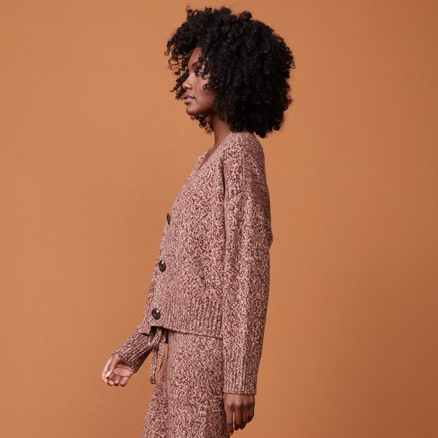 Side view of model wearing the marled oversized cardigan in pomegranate.