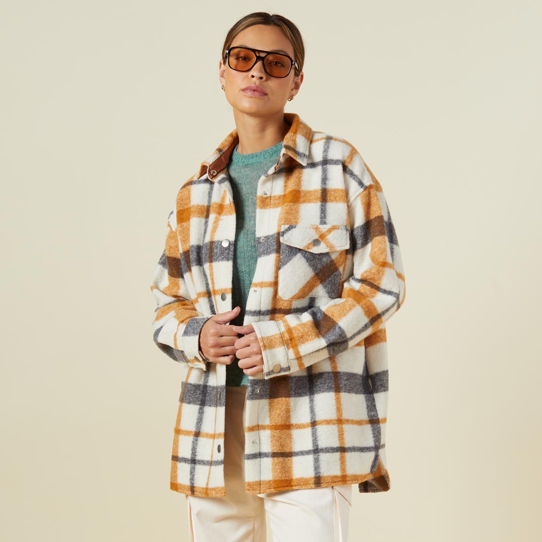 Front view of model wearing the plaid shacket in black, natural, caramel.