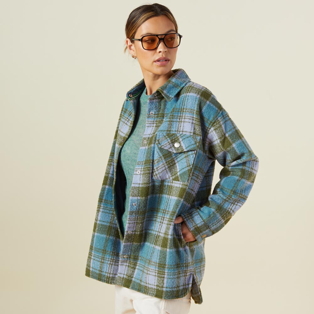 Side view of model wearing the plaid shacket in lilac/green/blue.