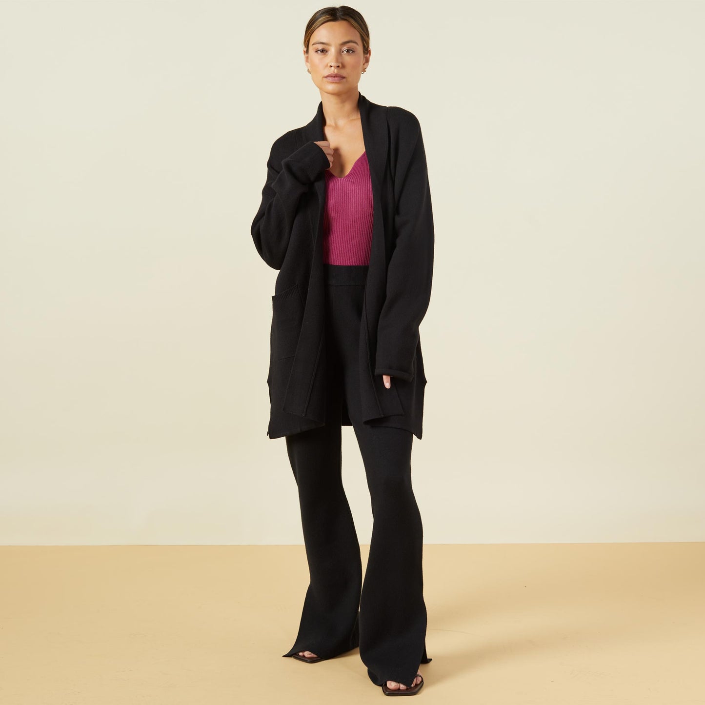 Front view of model wearing the supersoft sweater knit cardigan in black.