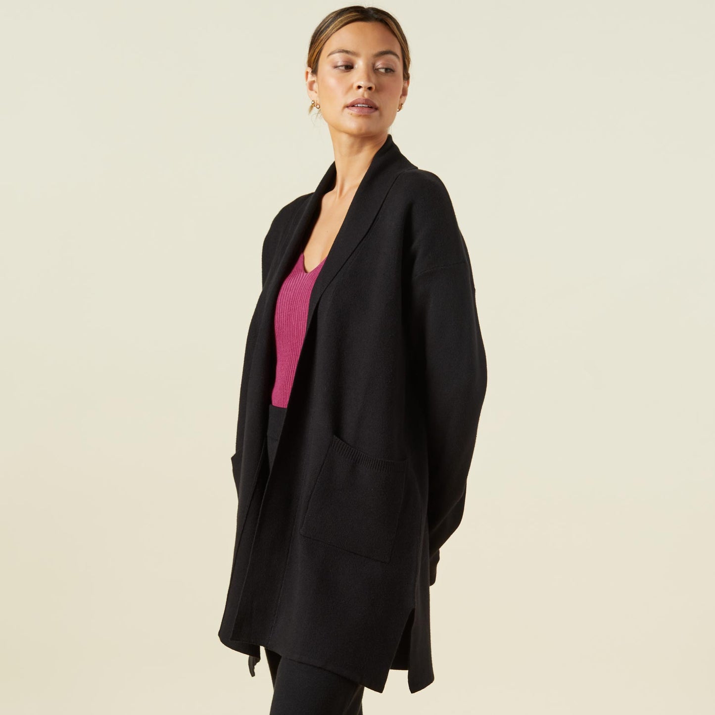 Side view of model wearing the supersoft sweater knit cardigan in black.