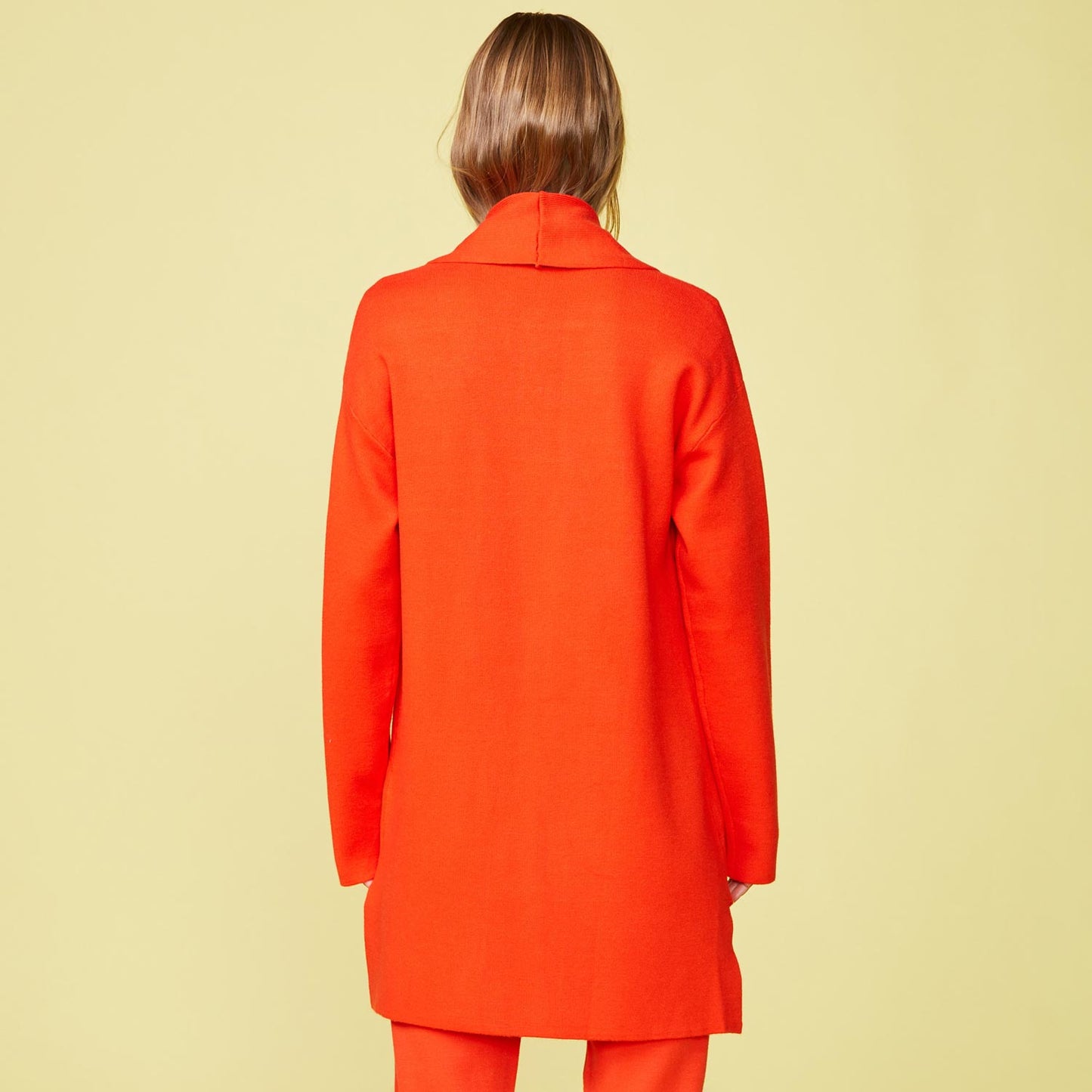 Back view of model wearing the Supersoft Sweater Knit Cardigan in Electric Coral.