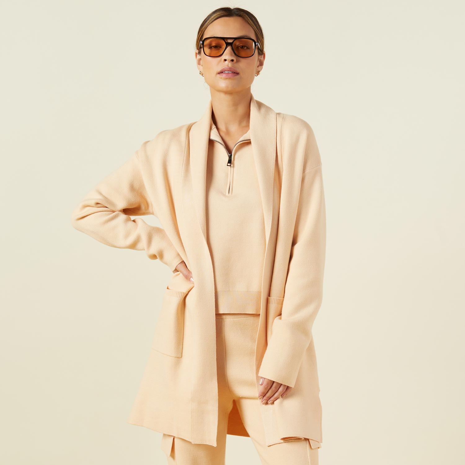 Front view of model wearing the supersoft sweater knit cardigan in vanilla.