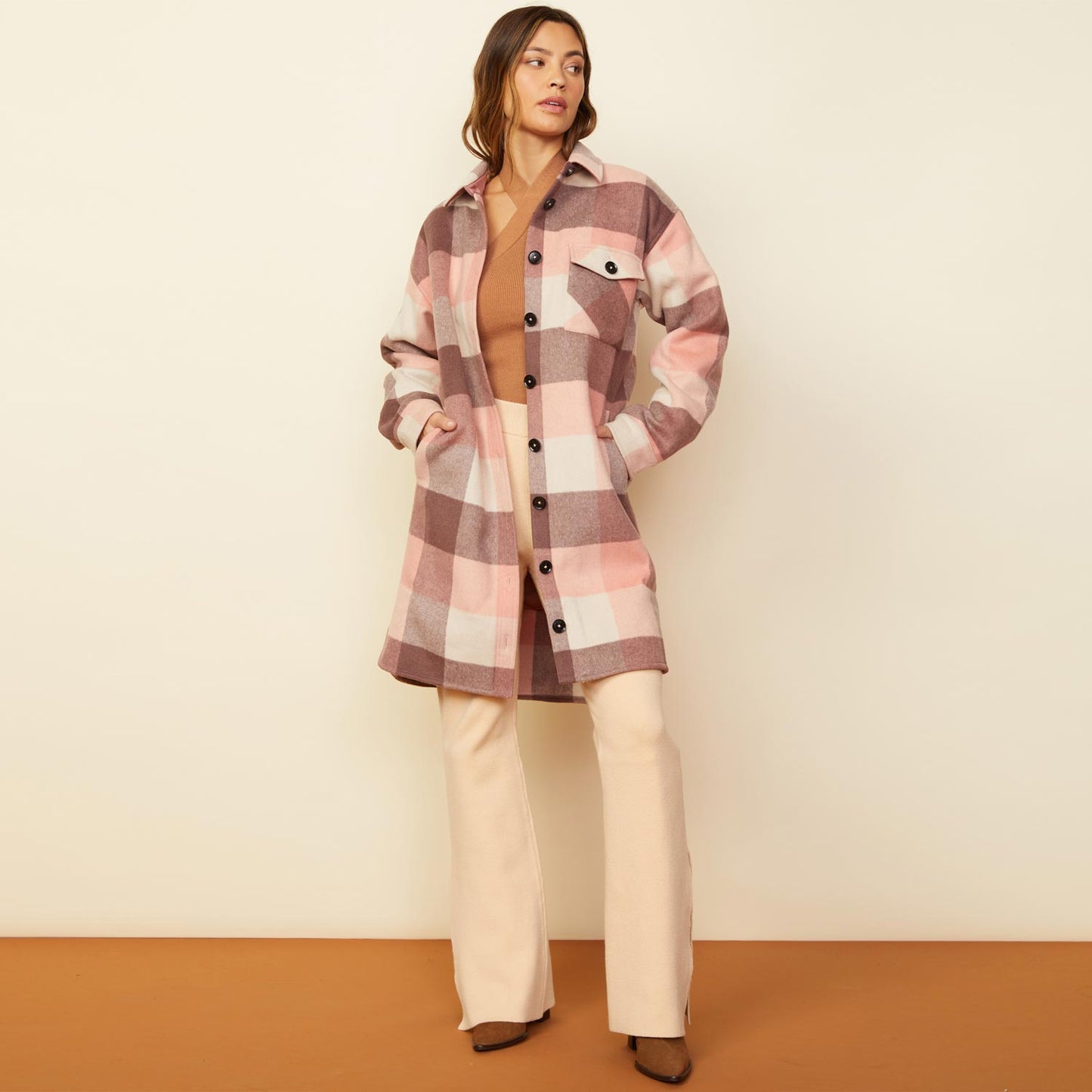 Front view of model wearing the long woolen shirt jacket in pink.
