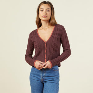 Front view of model wearing the double layer sweater cardigan in rhubarb.
