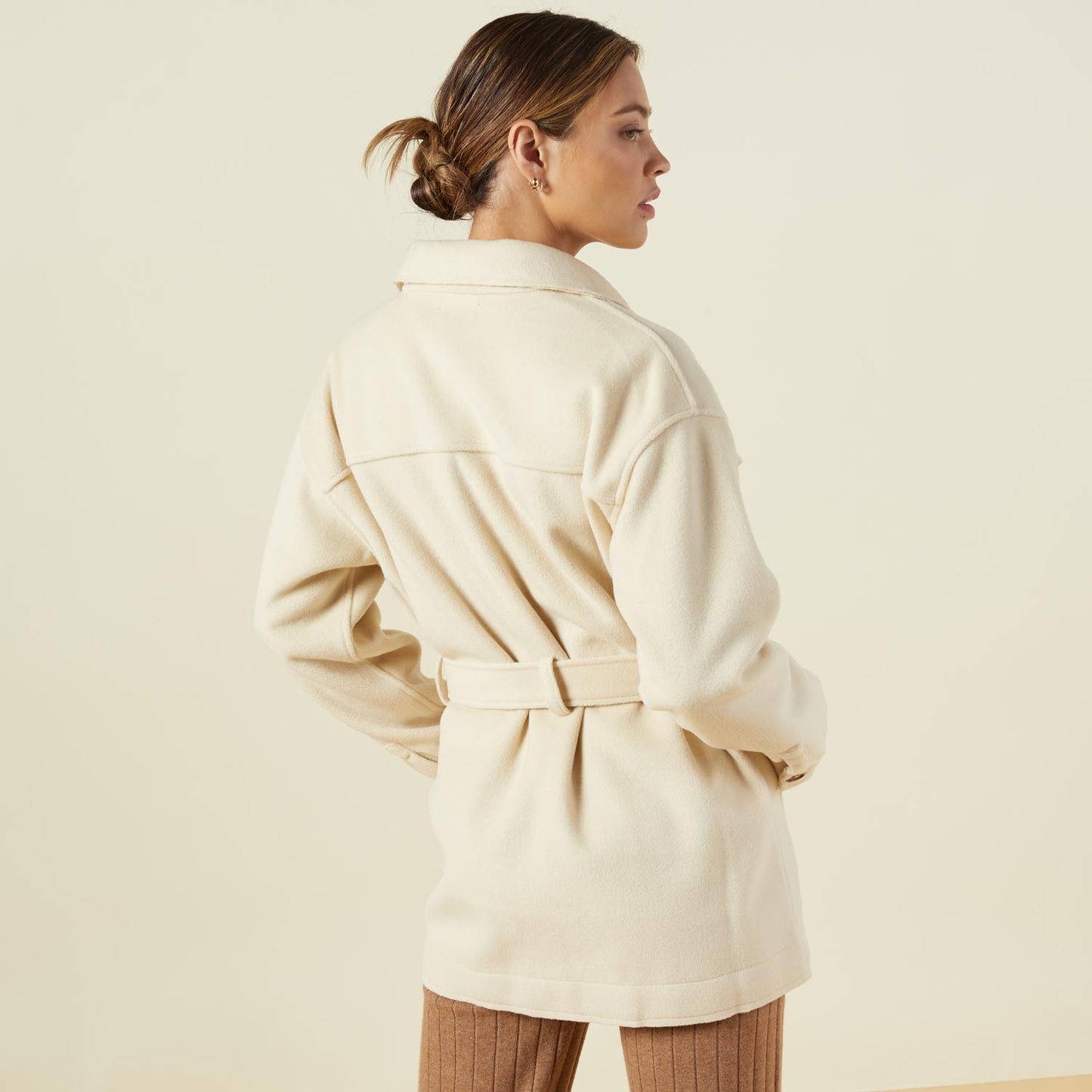 Back view of model wearing the safari jacket in off white.