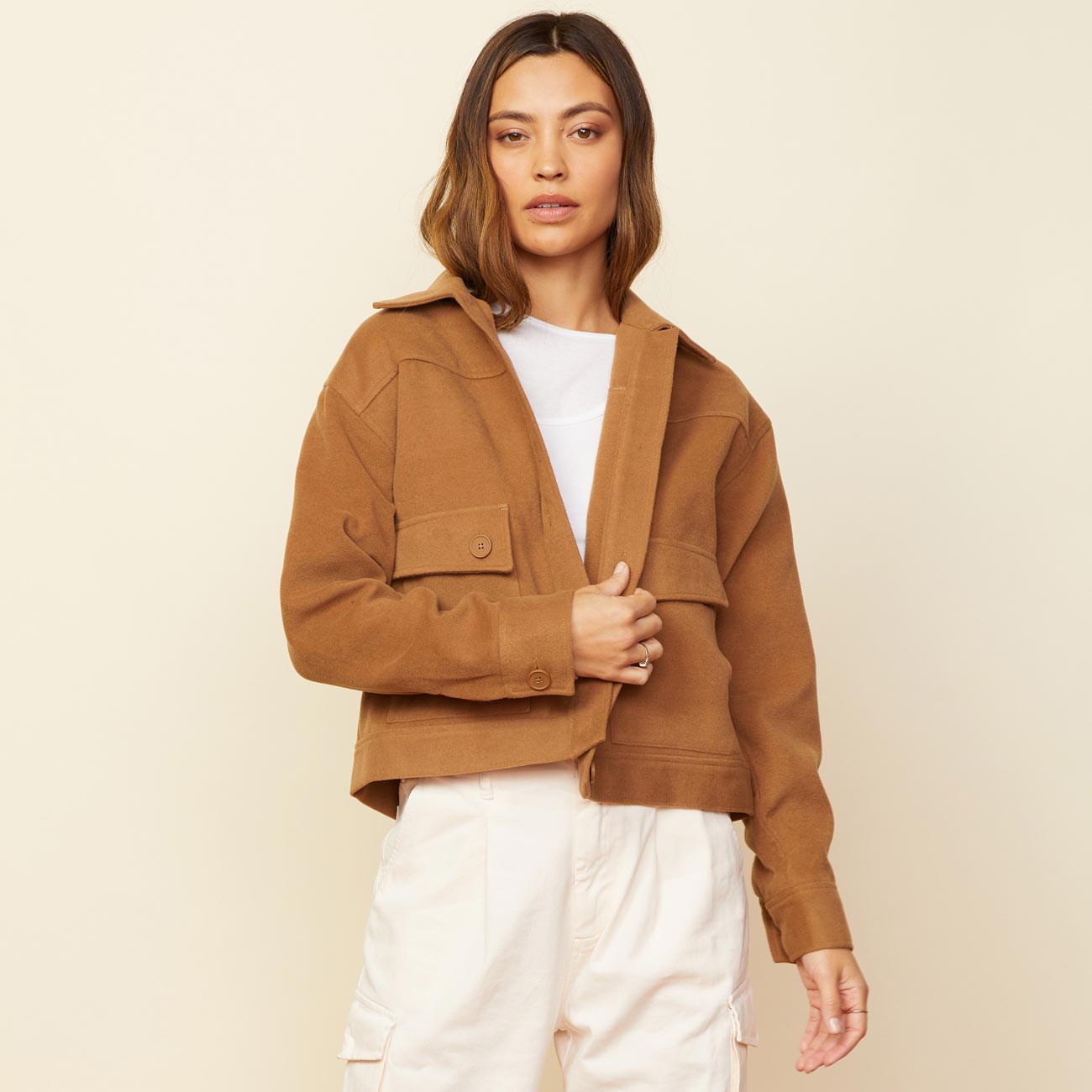 Front view of model wearing the weekend jacket in golden brown.