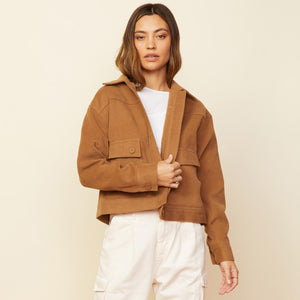 Front view of model wearing the weekend jacket in golden brown.