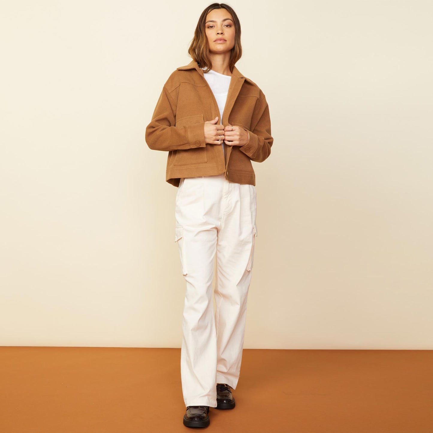 Front view of model wearing the weekend jacket in golden brown.