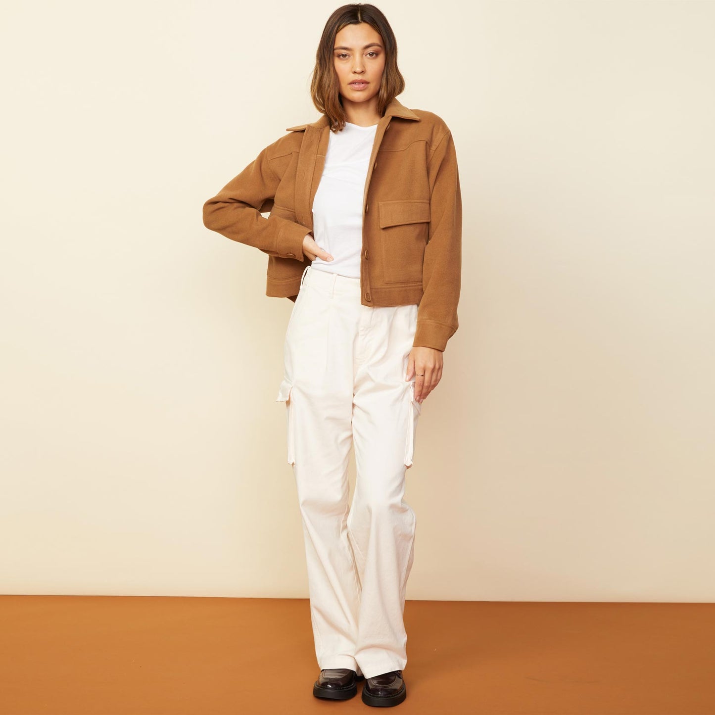 Front view of model wearing the weekend jacket in golden brown.