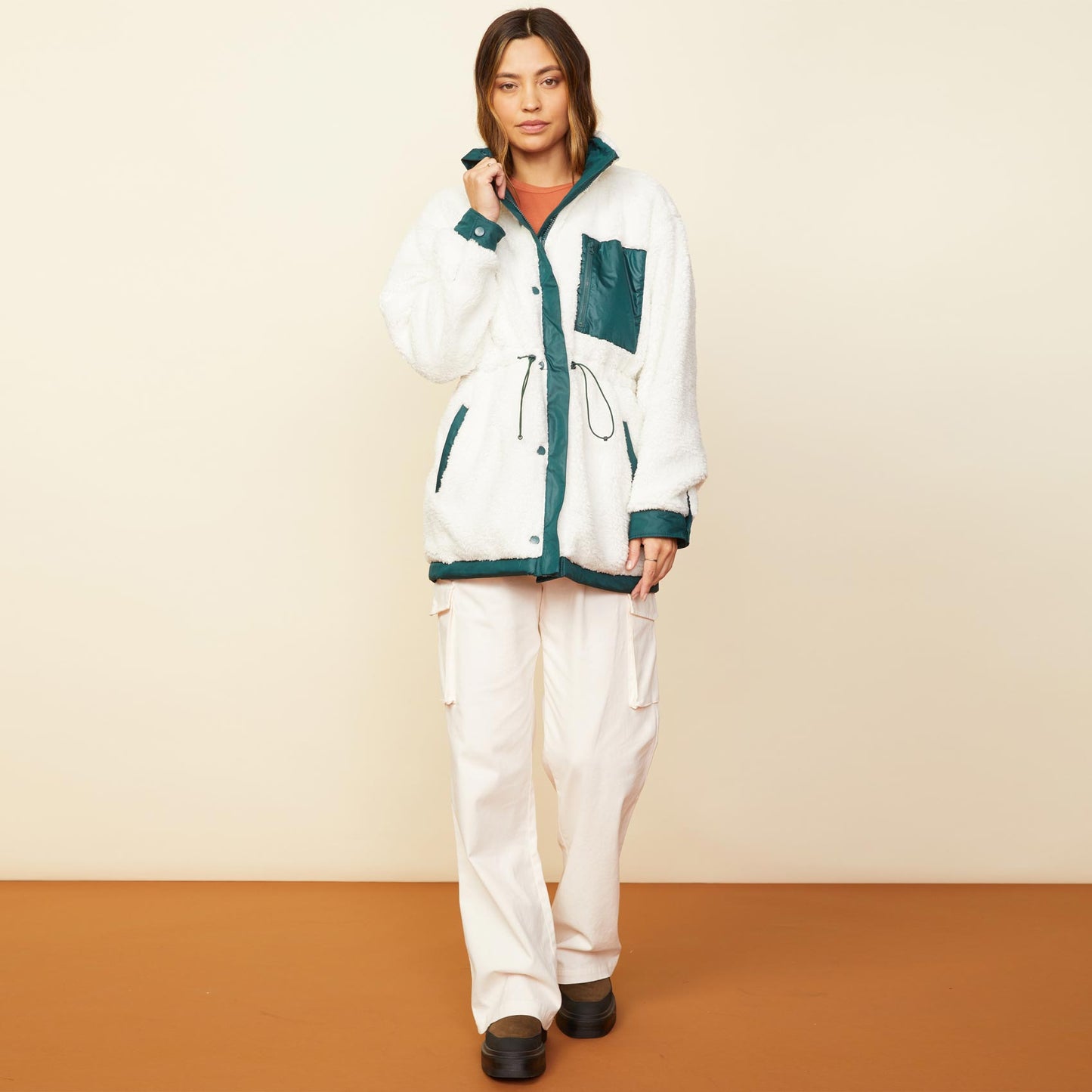 Front view of model wearing the reversible sherpa lined jacket in deep forest.