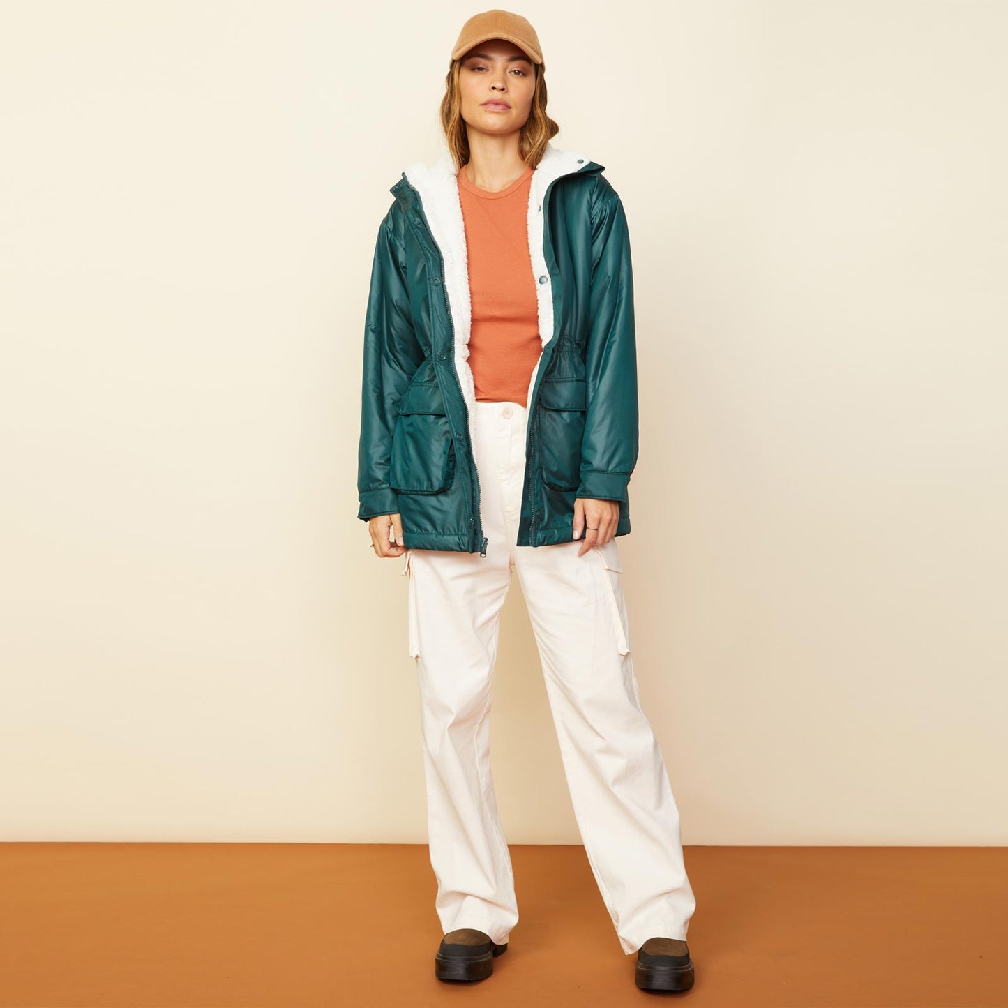 Front view of model wearing the reversible sherpa lined jacket in deep forest.