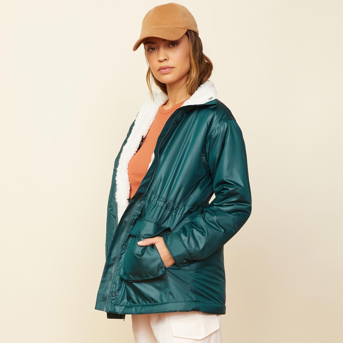 Side view of model wearing the reversible sherpa lined jacket in deep forest.