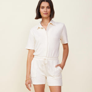 Front view of model wearing the supersoft romper in pearl.