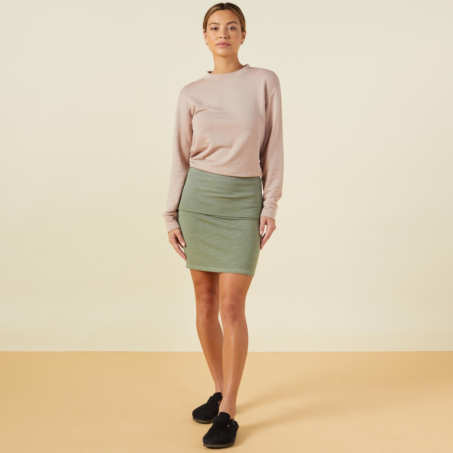Front view of model wearing the supersoft fold over skirt in laurel green.