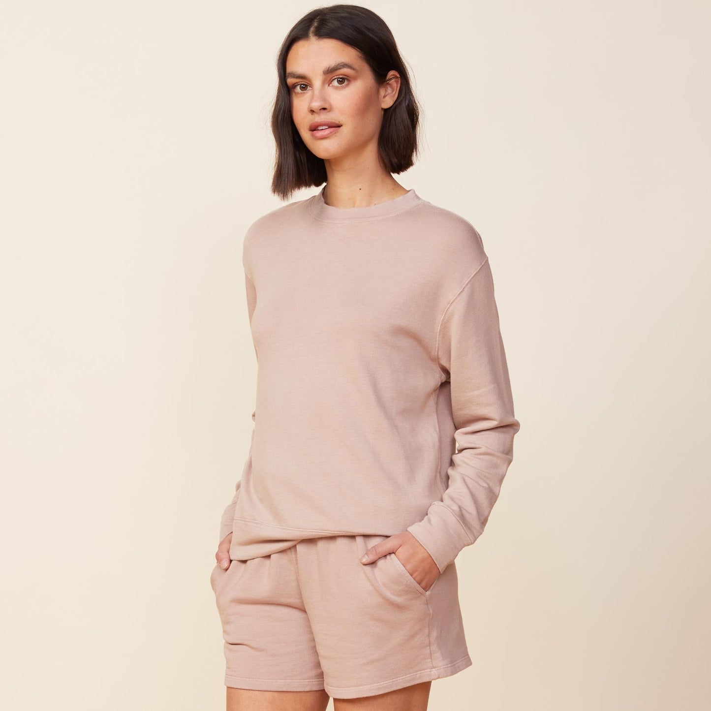 Side  view of model wearing the supersoft fleece boyfriend sweatshirt in taupe.