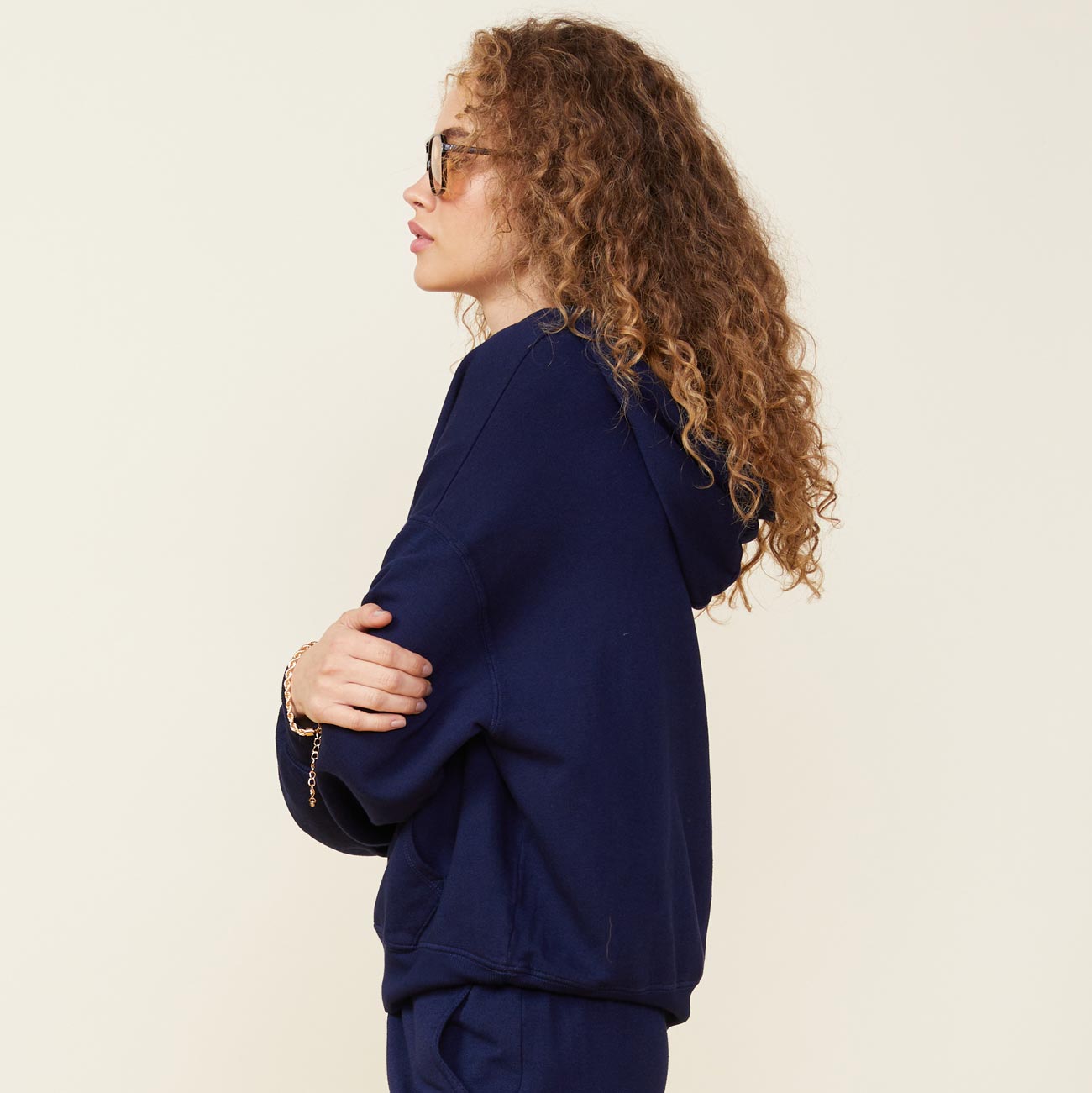 Side view of model wearing the supersoft fleece slouchy pullover in navy.