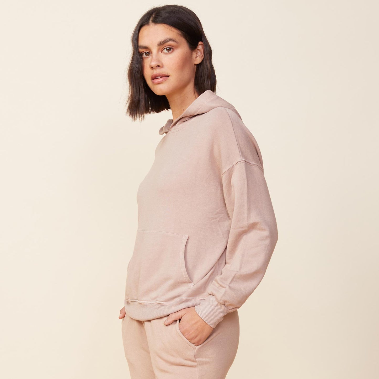 Side view of model wearing the supersoft fleece slouchy pullover in taupe.