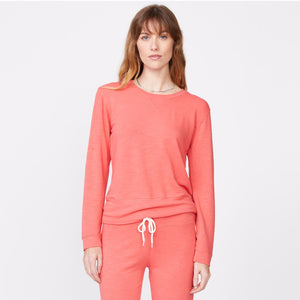 Front view of model wearing the supersoft crew neck sweatshirt in watermelon.