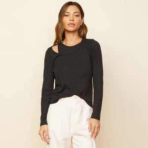 Front view of model wearing the asymmetric long sleeve top in black.