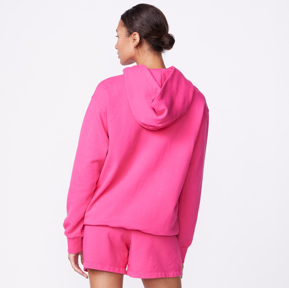 Back view of model wearing the 90's classic hoody in raspberry.