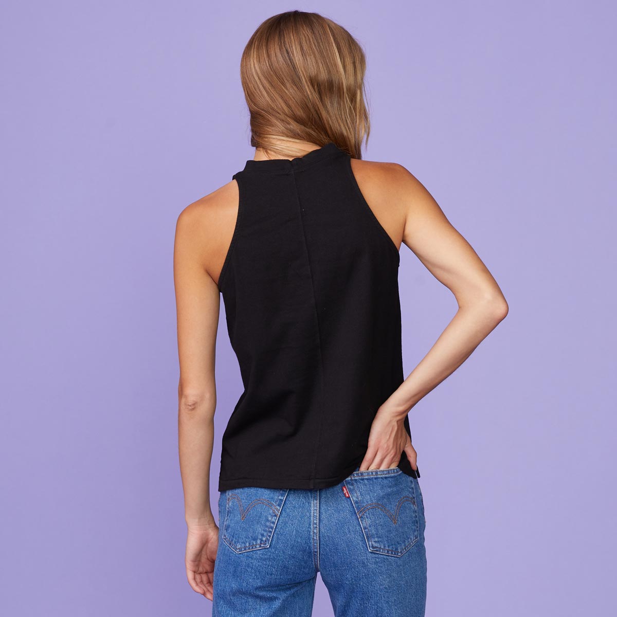 Back view of model wearing the halter tank in black.