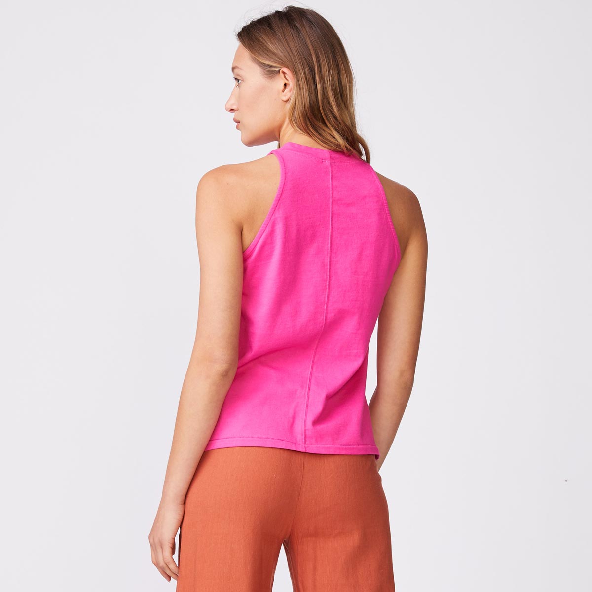 Back view of model wearing the halter tank in raspberry.