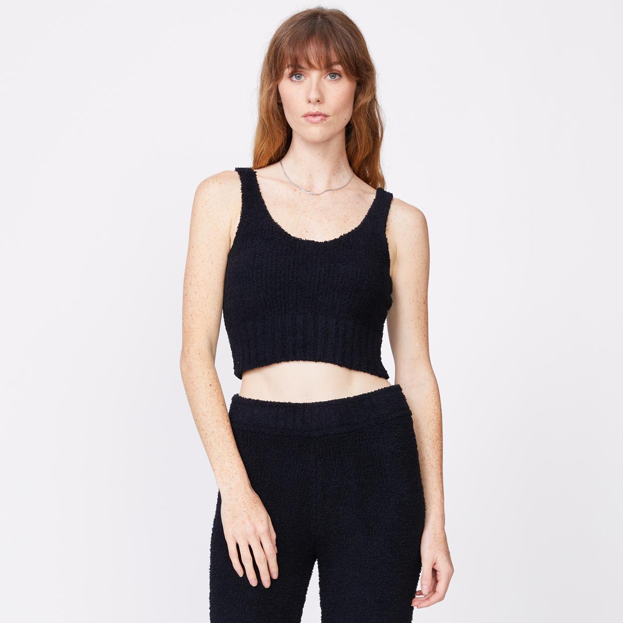 Front view of model wearing the plush sweater tank in black.