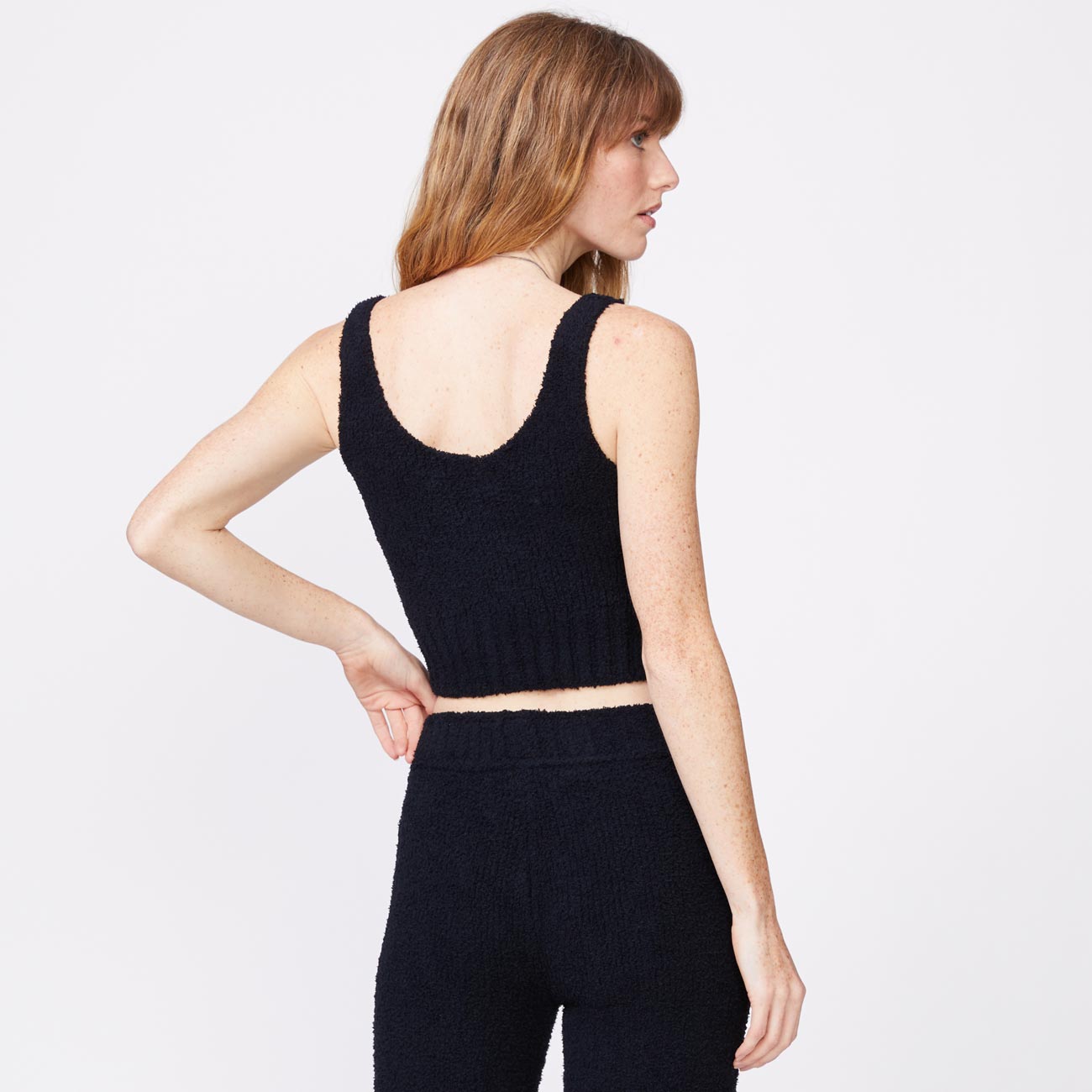 Back view of model wearing the plush sweater tank in black.