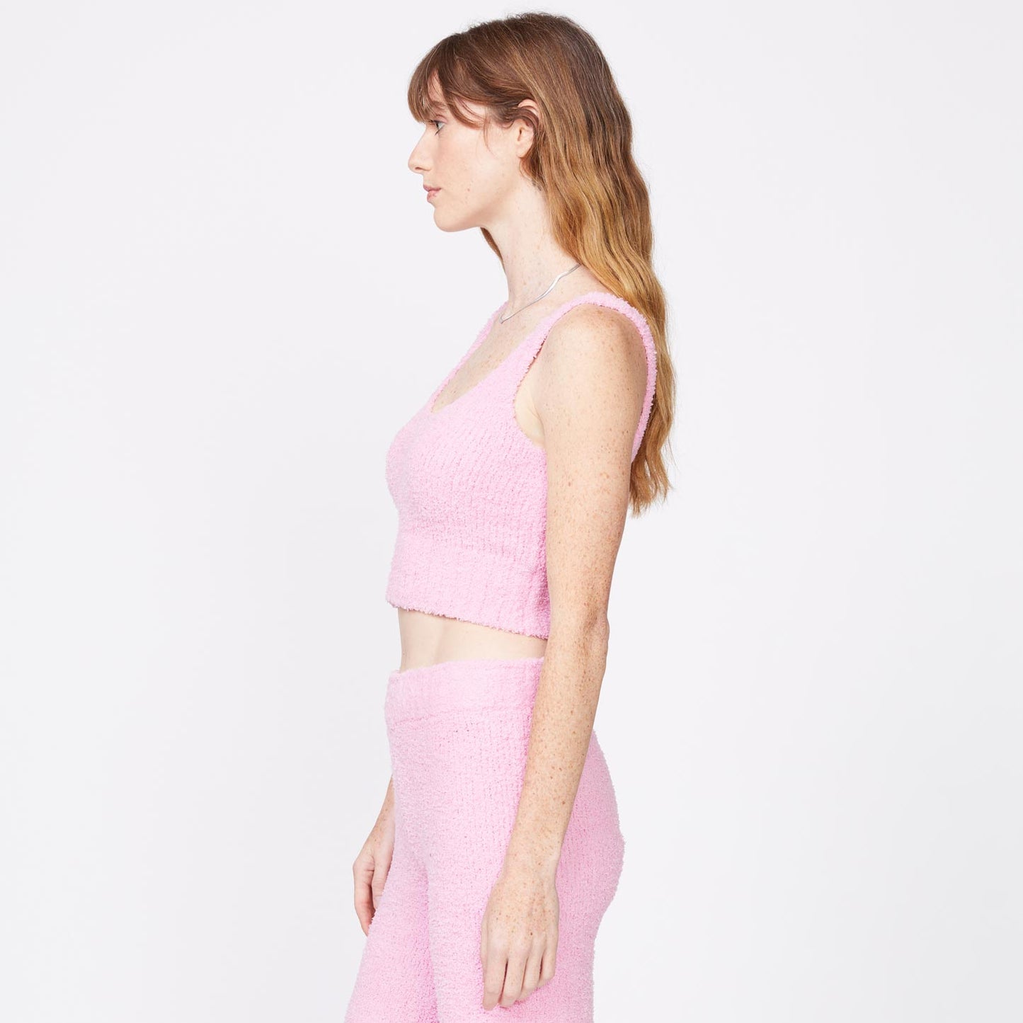Side view of model wearing the plush sweater tank in orchid.