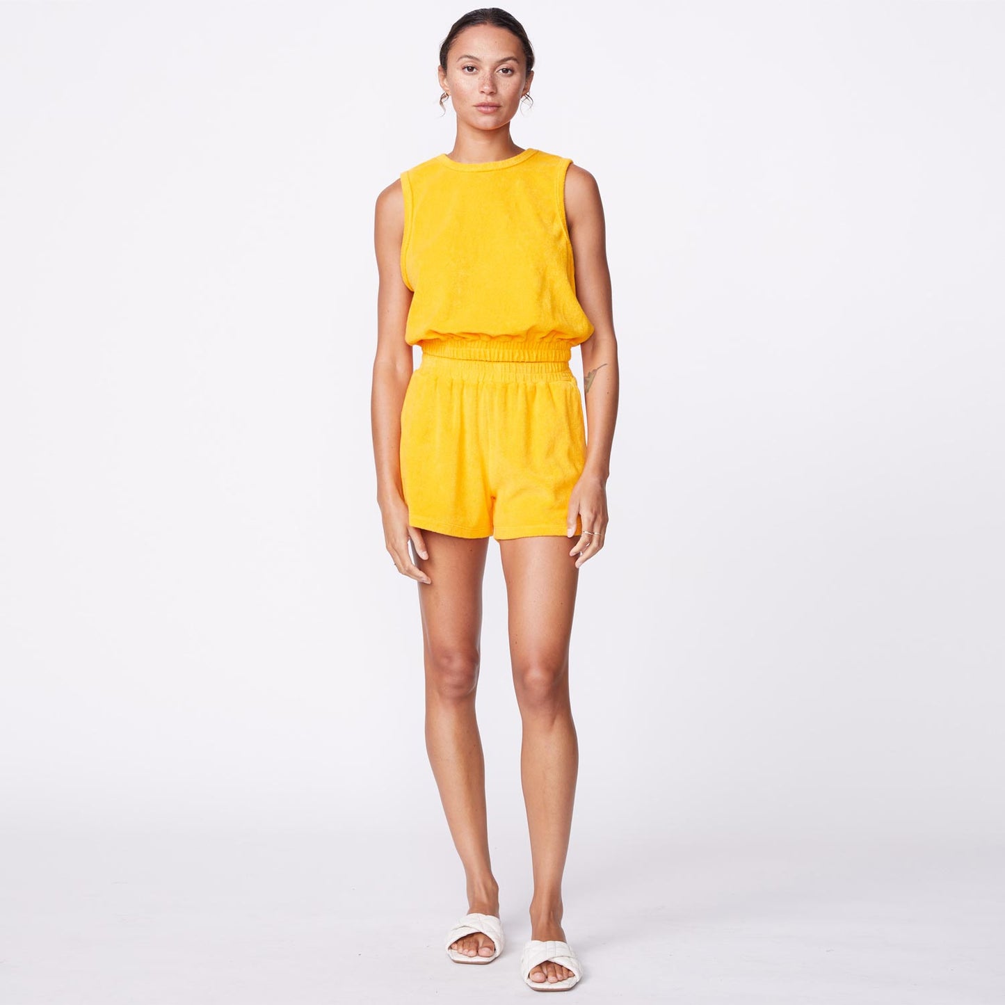 Front view of model wearing the terry cloth tank in marigold.