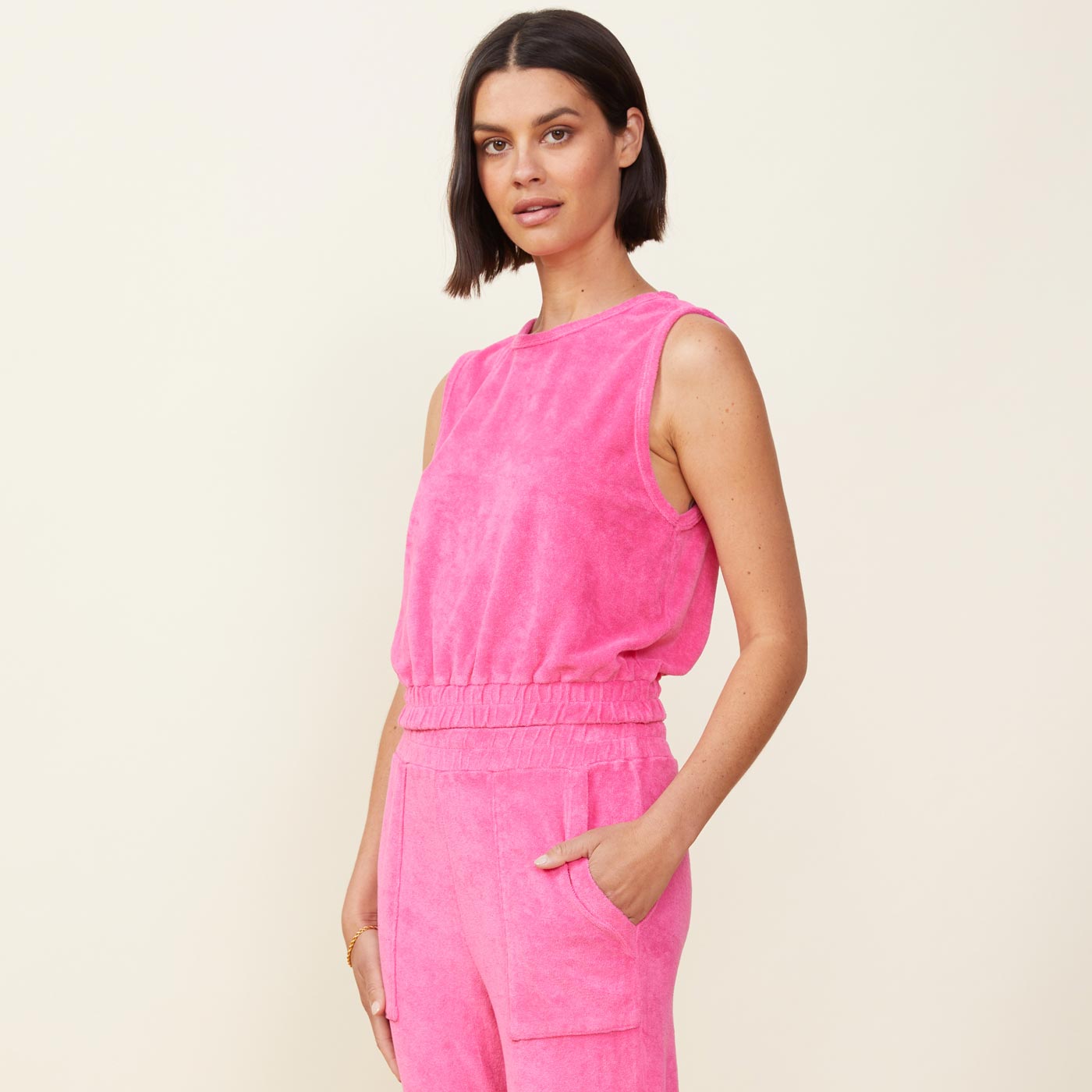 Side view of model wearing the terry cloth tank in rose bud.