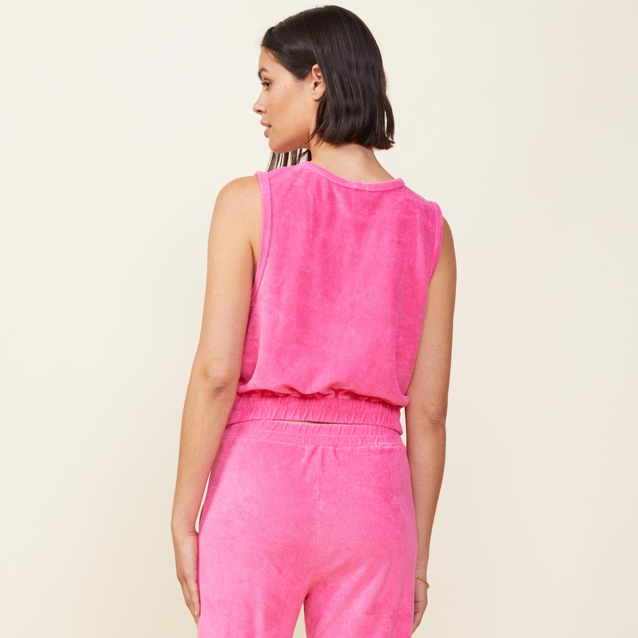 Back view of model wearing the terry cloth tank in rose bud.
