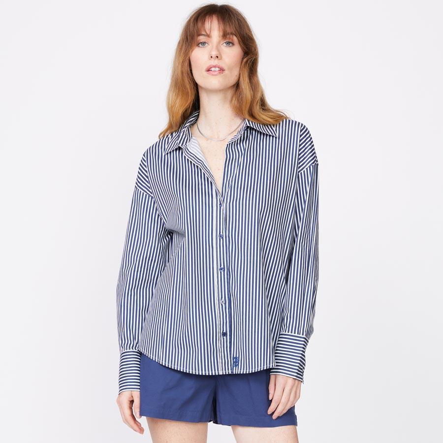 Front view of model wearing the stretch poplin stripe shirt in french navy.