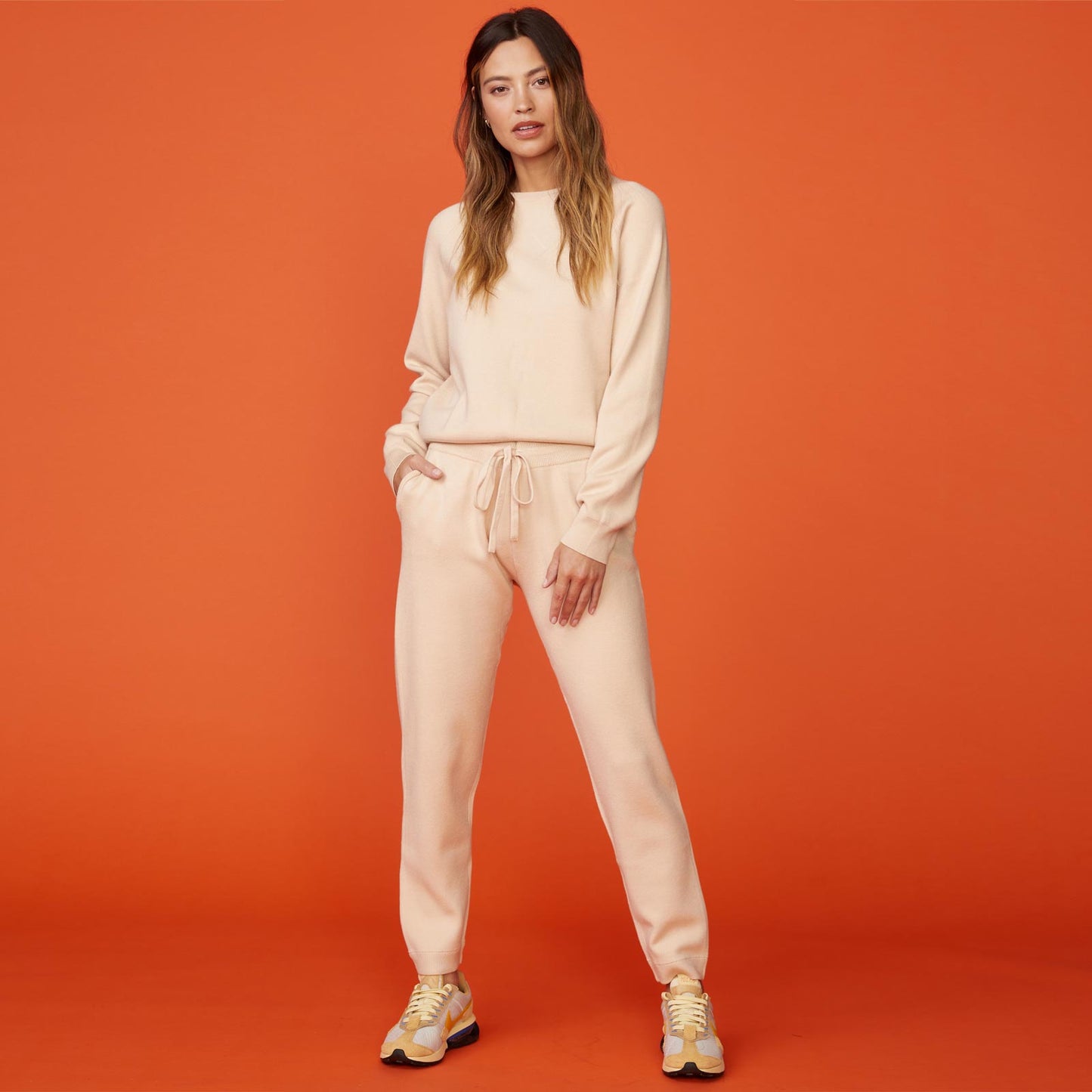 Front view of model wearing the supersoft sweater knit cuffed jogger in off white.