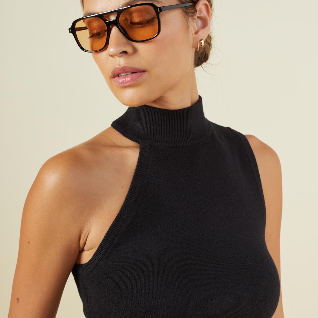 Close up view of model wearing the supersoft sweater knit asymmetric mock neck tank in black.