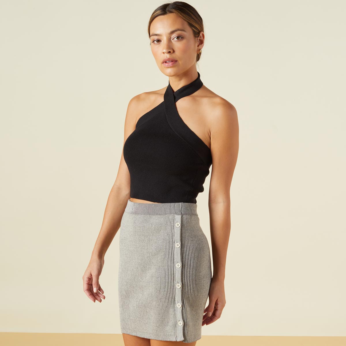 Side view of model wearing the supersoft sweater knit halter in black.