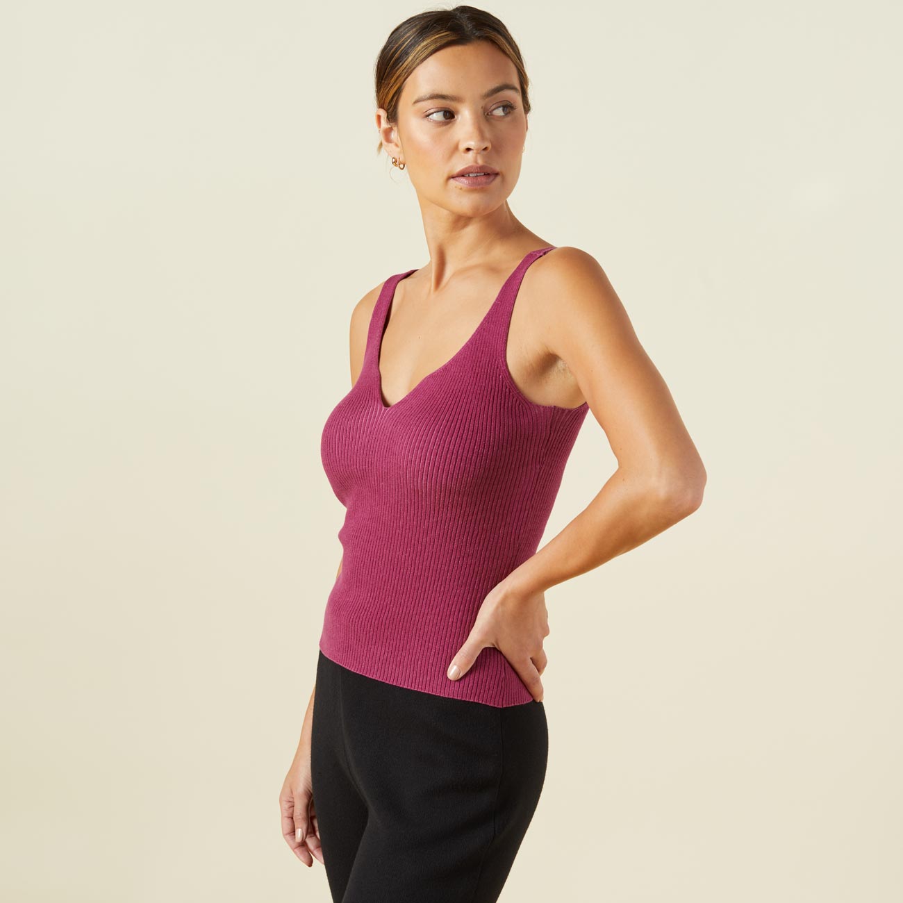 Side view of model wearing the sweater rib tank in raspberry rose.