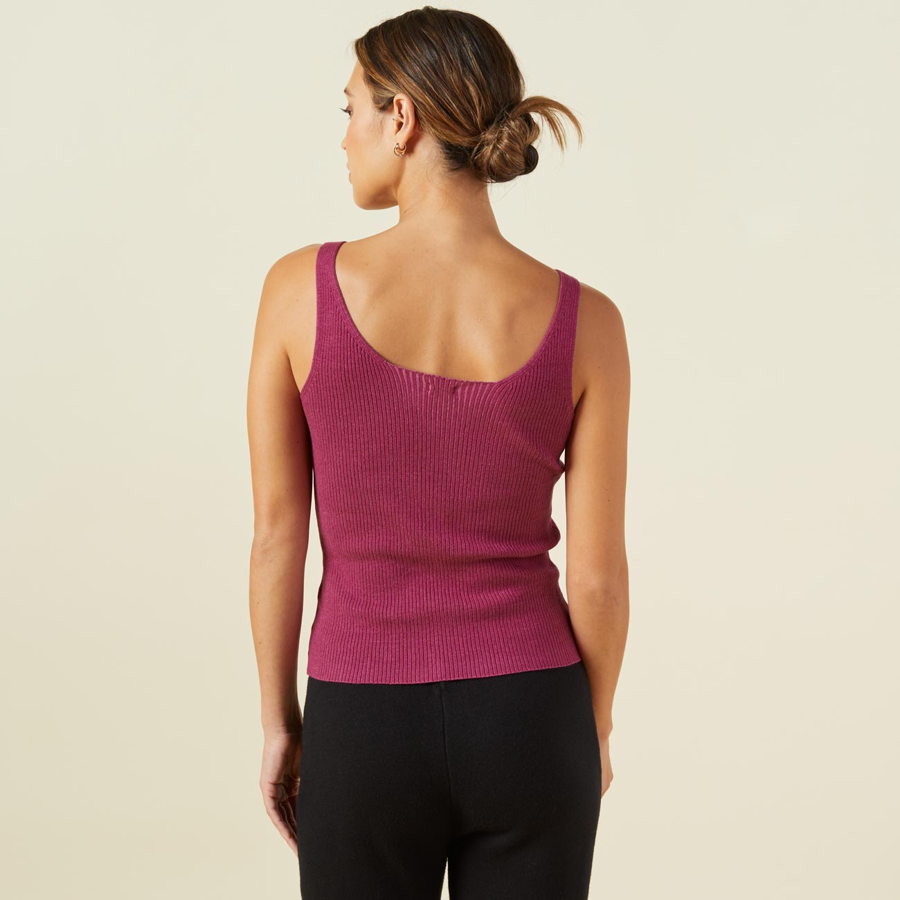 Back view of model wearing the sweater rib tank in raspberry rose.
